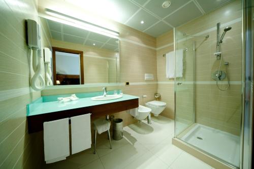 a bathroom with a sink and a shower and a toilet at Hotel D'Este in Milan