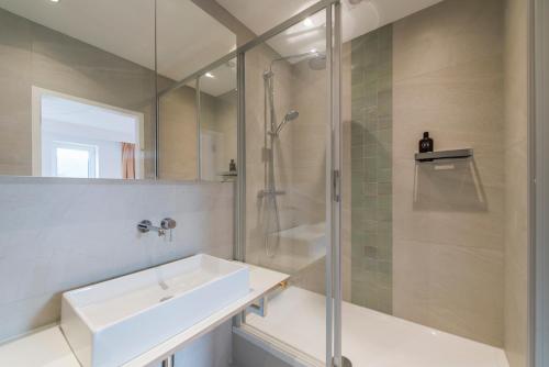 a bathroom with a sink and a shower at Studio des jardins suspendus in Liège