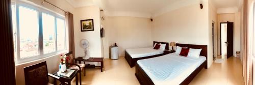 Ένα ή περισσότερα κρεβάτια σε δωμάτιο στο Nam Long Plus Hotel