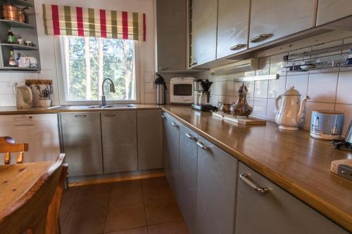 a kitchen with a wooden counter top in a kitchen at Villa Harald - Beachfront in Hitis