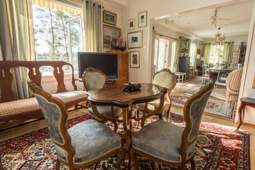 a dining room with a table and chairs at Villa Harald - Beachfront in Hitis