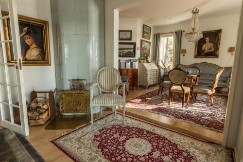 a living room with chairs and a rug at Villa Harald - Beachfront in Hitis