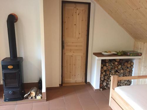 a room with a wood stove next to a door at U Kryštofa in Luže