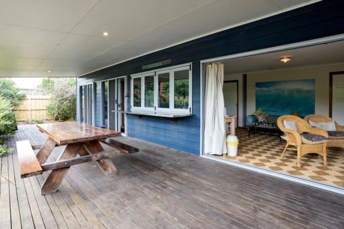 a porch of a house with a wooden table at Beautiful, Cosy and Quiet in Cape Paterson