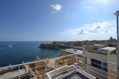 a view of the ocean from the balcony of a building at Valletta Dream Suites in Valletta