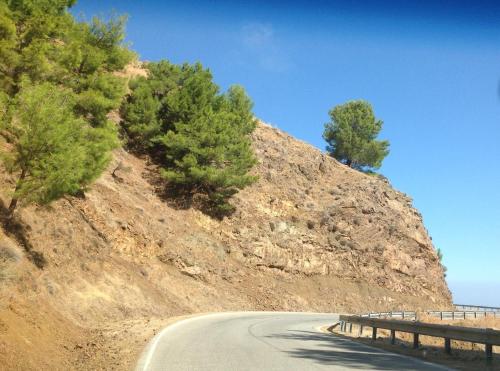 a road on the side of a hill with trees at Pomos Idol Exceptional Beach Villa in Pomos