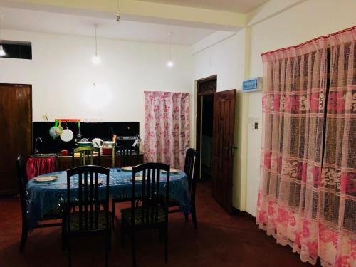 a dining room with a blue table and chairs at Seagull's Nest in Tangalle