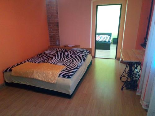 a bedroom with a zebra print bed in a room at Gospodarstwo u Krakusa in Doboszowice