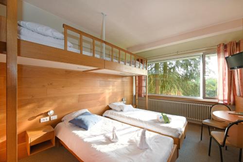 Posteľ alebo postele v izbe v ubytovaní Mont-Des-Pins Domaine de Vacances, Vakantiedomein Dennenheuvel