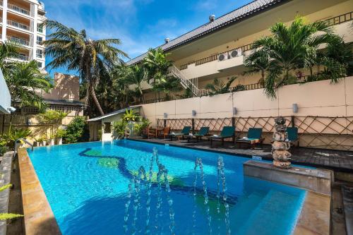 a swimming pool in front of a building at Bella Villa Metro in North Pattaya