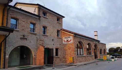 a building with a clock on the front of it at Hotel Locanda Dolce Vita in San Donà di Piave