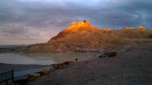 a mountain sitting on the side of a body of water at Case Vacanze Levante in Vulcano