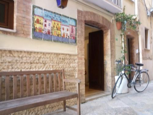 a bike parked next to a building with a bench at B&B Vento di Terra in Gaeta