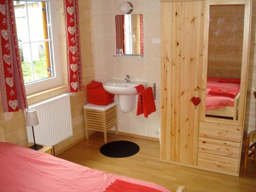 a small bathroom with a sink and a sink at Haus Servus in Klösterle