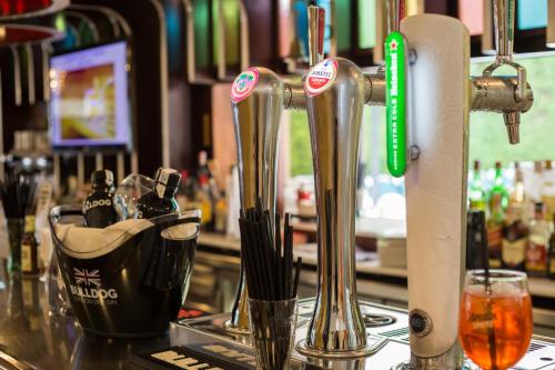 a bar with a counter with silver utensils at Cleopatra Spa Hotel in Lloret de Mar
