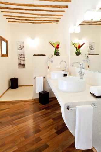 a bathroom with two sinks and a wooden floor at Essque Zalu Zanzibar in Nungwi