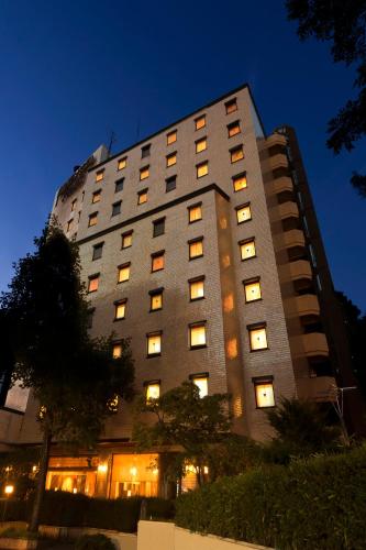 a tall building with many windows at night at Morioka Grand Hotel Annex in Morioka