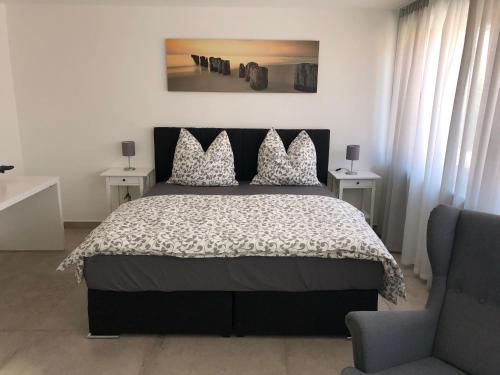 a bedroom with a bed with a black and white comforter at S-AN Daily Room Stuttgart Zentrum in Stuttgart