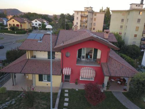 a red house with a red roof at B&b la valletta in Serravalle Scrivia