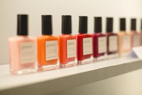 a row of nail polish sitting on a shelf at Les Terrasses d'Eze - Hôtel & Spa in Èze