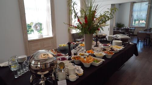 a long table with a buffet of food on it at Hotel Jakubus in Wilków