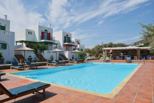 a pool at a hotel with chairs and umbrellas at Country Villas in Stelida