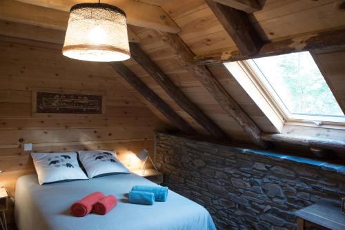 a bedroom with two beds in a log cabin at Le Castanier in Montauban-de-Luchon