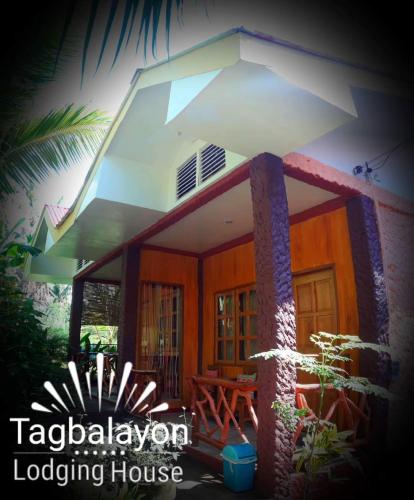 a small house with a porch with a roof at TAGBALAYON Lodging House in Siquijor