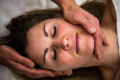 a woman with her hands on her head with her eyes closed at La Bouitte - Hôtel Relais & Châteaux in Saint-Martin-de-Belleville