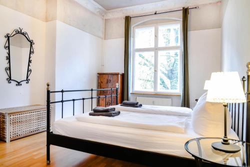 a bedroom with two beds and a window at Apartment Winsstr. 68 in Berlin