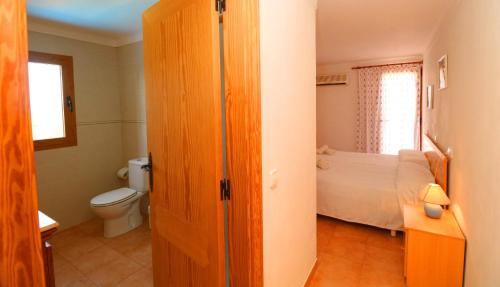 Habitación con baño con cama y aseo. en Sa Pedrera en Campos