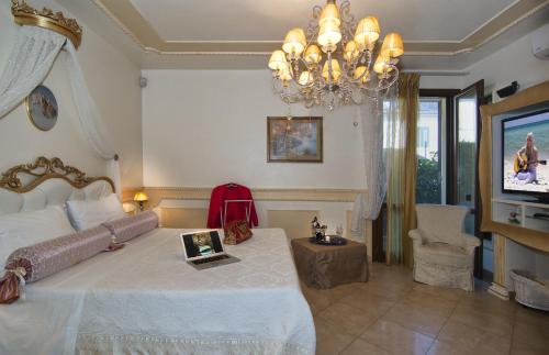 Un dormitorio con una cama grande y una lámpara de araña. en Il Dolce Sospiro, en Pisa