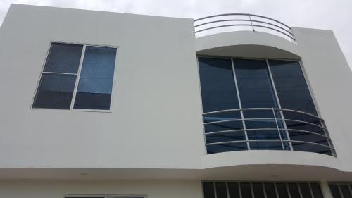 a white building with windows and a balcony at Condominio Santa Hagia Sofia - Casa y 2 apartamentos in Flandes