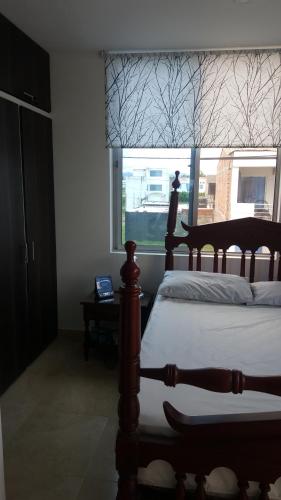 a bedroom with a large bed and a window at Condominio Santa Hagia Sofia - Casa y 2 apartamentos in Flandes