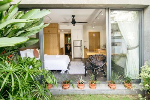 a living room with plants in pots on a patio at Sen Boutique House By 5H in Ho Chi Minh City