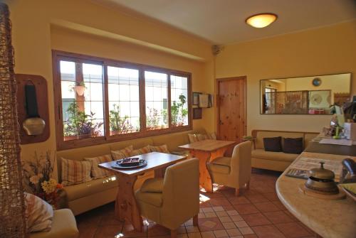 a living room with a couch and a table at Albergo La Pineta in Marina di Andora