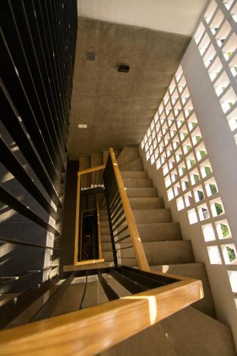 a spiral staircase in a building with a window at Sen Boutique House By 5H in Ho Chi Minh City
