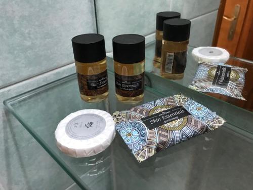 three bottles of essential oils sitting on a glass table at Hotel Antigoni in Neochori