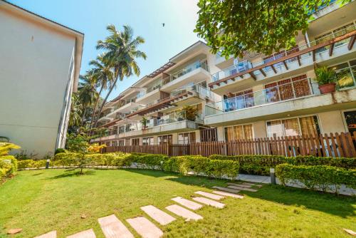 an apartment building with a lawn in front of it at Eternal wave by HappyInch in Calangute