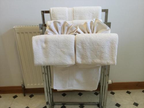 two towels sitting on a chair in a room at Two-Bedroom Apartment - Golf View Free Parking in Inverness