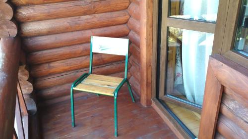 a chair sitting in a room next to a window at Georgiy in Oryavchyk