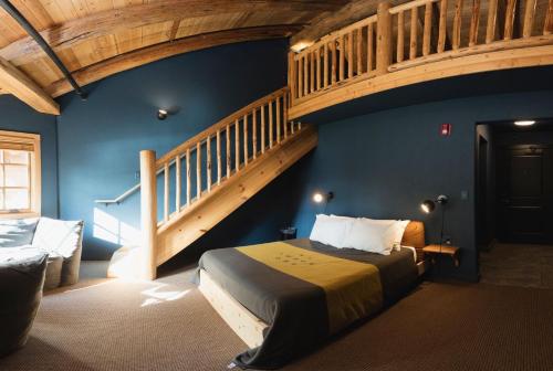 a bedroom with a bed and a staircase in a room at The Suttle Lodge & Boathouse in Camp Sherman