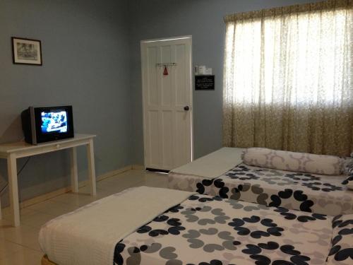 Postel nebo postele na pokoji v ubytování Nipah Guesthouse Pangkor