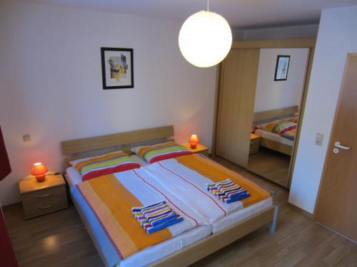 a bedroom with a bed with towels on it at Brockenapartments in Schierke