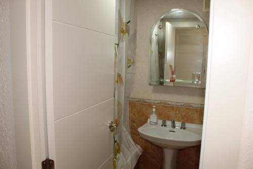 a bathroom with a sink and a mirror at Resitur Luxury Suit 2 in Seville