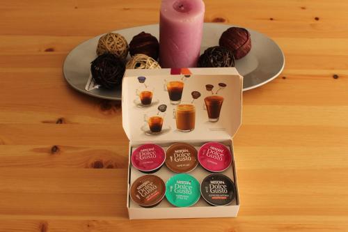 a box of donuts and a candle and a plate at Resitur Luxury Suit 2 in Seville