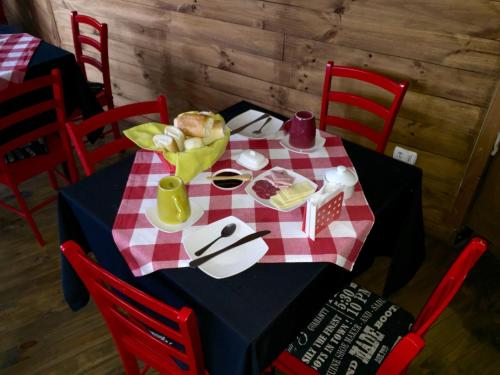 a table with a red and white checkered table cloth at Hostal Esquina Patagónica in Coihaique
