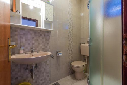a bathroom with a sink and a toilet at Apartman Laura in Selce