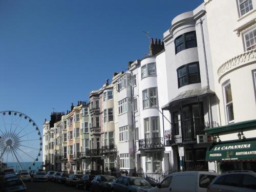 a row of buildings on a street with a ferris wheel at Aquarium Guest House in Brighton & Hove