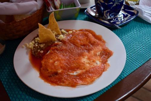 a white plate with food on a table at Hotel Ana Catalina and Suites in San Miguel de Allende